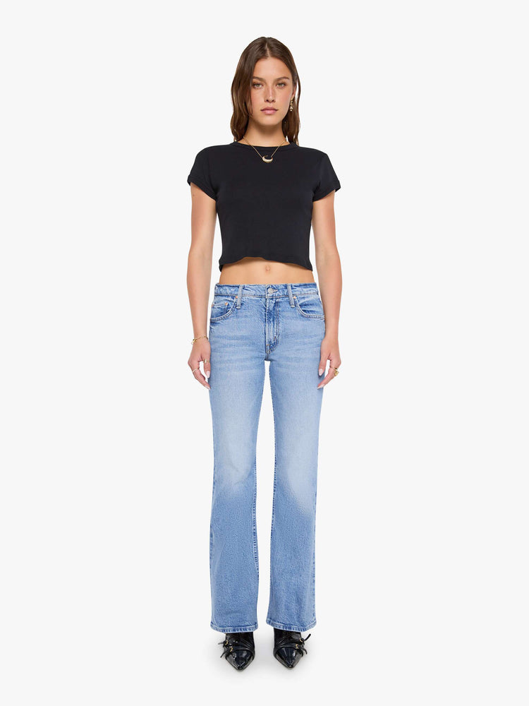 Front view of a woman in a lower-rise bootcut jean with a zip fly, long 32-inch inseam and a clean hem.