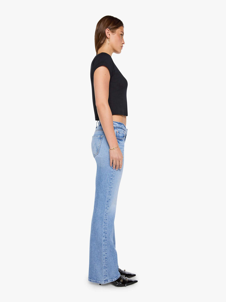 Side view of a woman in a lower-rise bootcut jean with a zip fly, long 32-inch inseam and a clean hem.