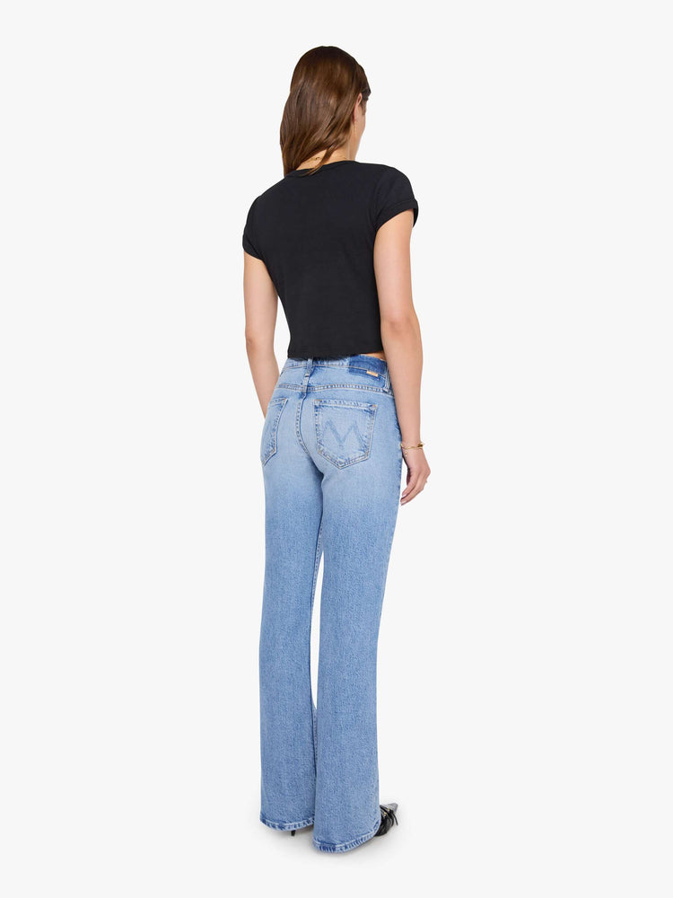 Back view of a woman in a lower-rise bootcut jean with a zip fly, long 32-inch inseam and a clean hem.