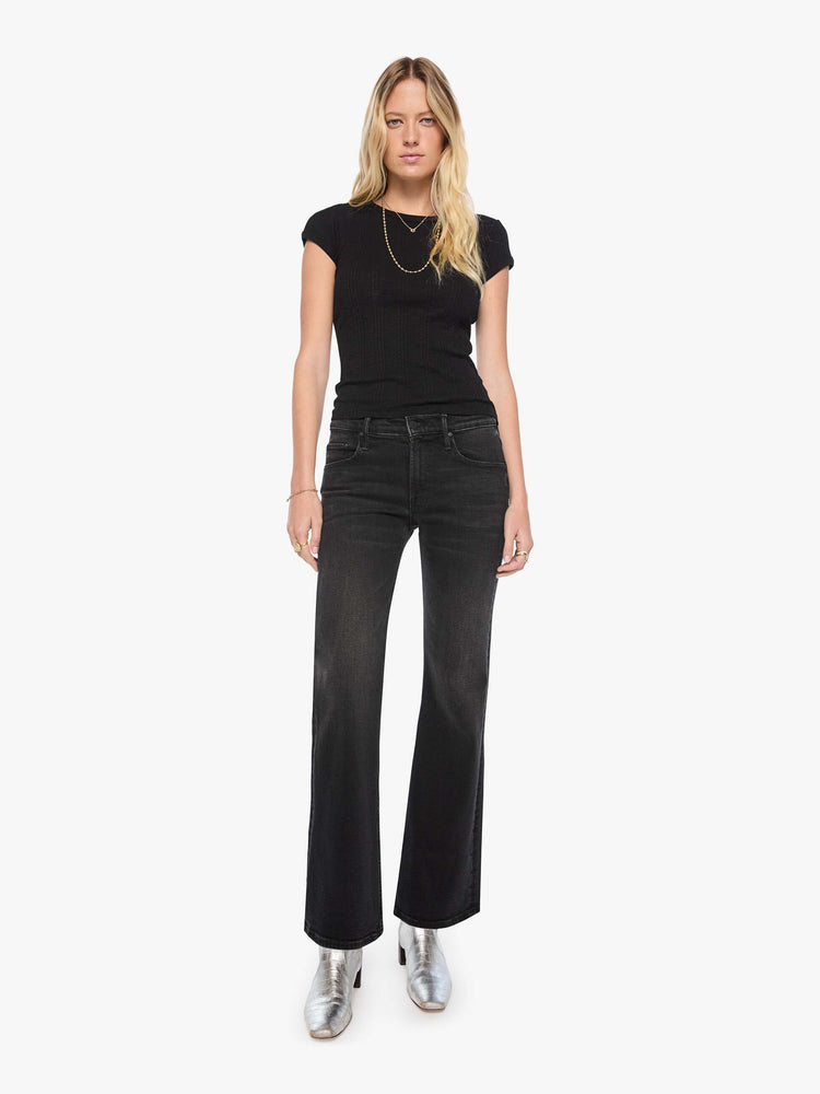 Front view of a woman in mid-rise bootcut jean with a long 32-inch inseam and a clean hem.