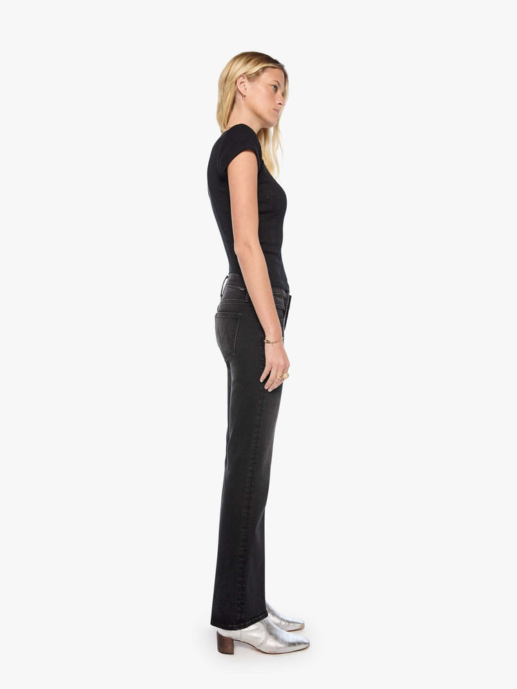 Side view of a woman in mid-rise bootcut jean with a long 32-inch inseam and a clean hem.