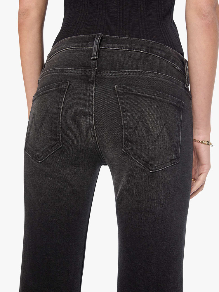 Close up view of a woman in mid-rise bootcut jean with a long 32-inch inseam and a clean hem.