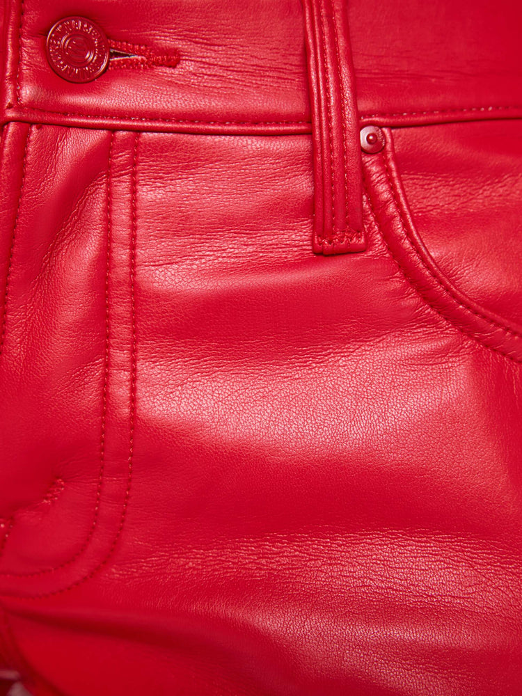 Swatch view of a woman in a cherry red lower-rise bootcut pant with a long 32-inch inseam and a clean hem.