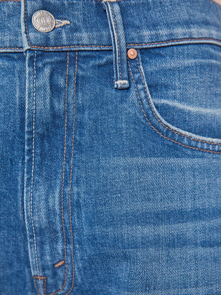 Swatch view of a woman in a mid-blue super high-waisted barrel-leg jeans with an ankle-length inseam, zip fly, clean hem and relaxed fit.