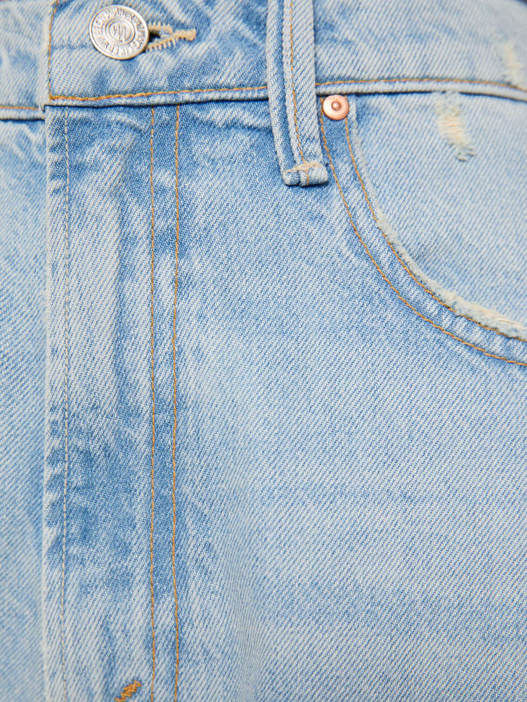 Swatch view of a woman in a light blue super high-waisted barrel-leg jeans with a relaxed fit, zip fly, inset panels on the outer seams, long 32-inch inseam and a clean hem.