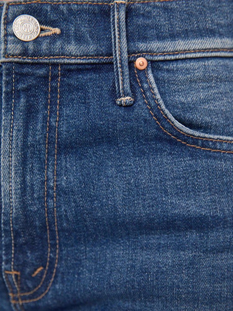 Swatch view of a woman in a med blue high-rise straight-leg jean with a zip fly, 31-inch inseam and a frayed hem.