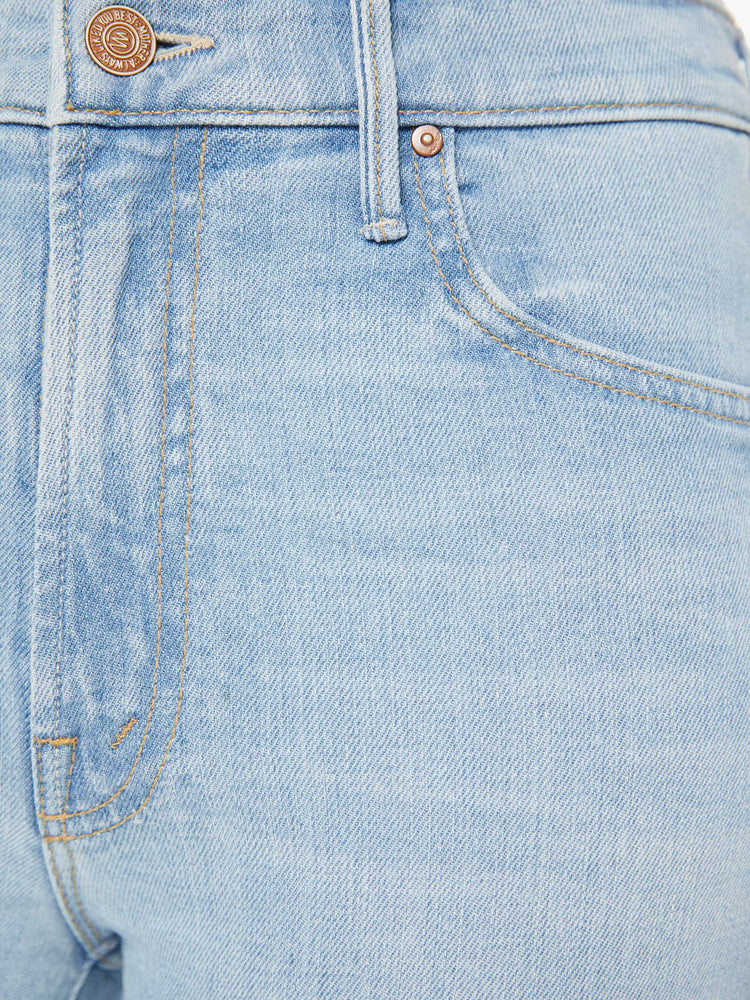 Swatch view of a woman in a light blue high-waisted bootcut is cropped at the ankle with a zip fly and a frayed step-hem.