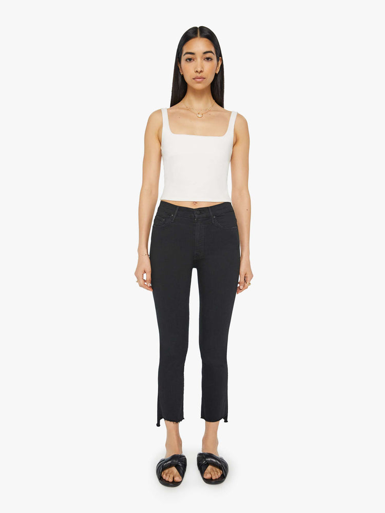 Front view of women’s black cropped bootcut jean with a step frayed hem.