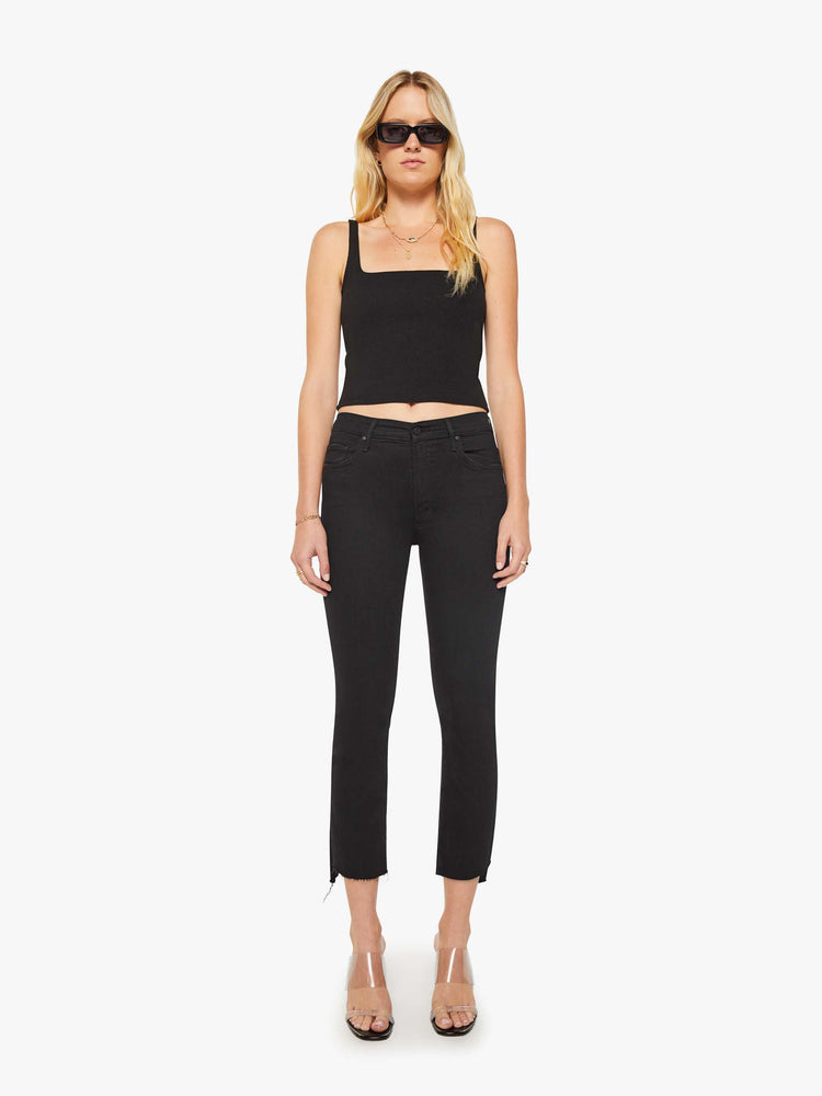 Front view of women’s black cropped bootcut jean with a step frayed hem.