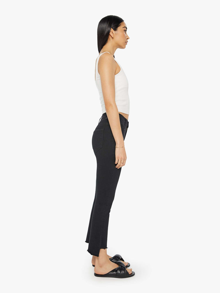 Side view of women’s black cropped bootcut jean with a step frayed hem.