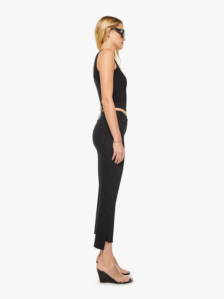 Side view of women’s black cropped bootcut jean with a step frayed hem.
