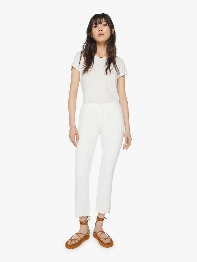 Front view of women’s white cropped bootcut with step frayed hem.