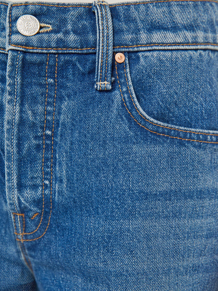 Swatch view of a woman in a classic blue high-rise straight leg denim capri with a zip fly, 16-inch inseam and a frayed hem.