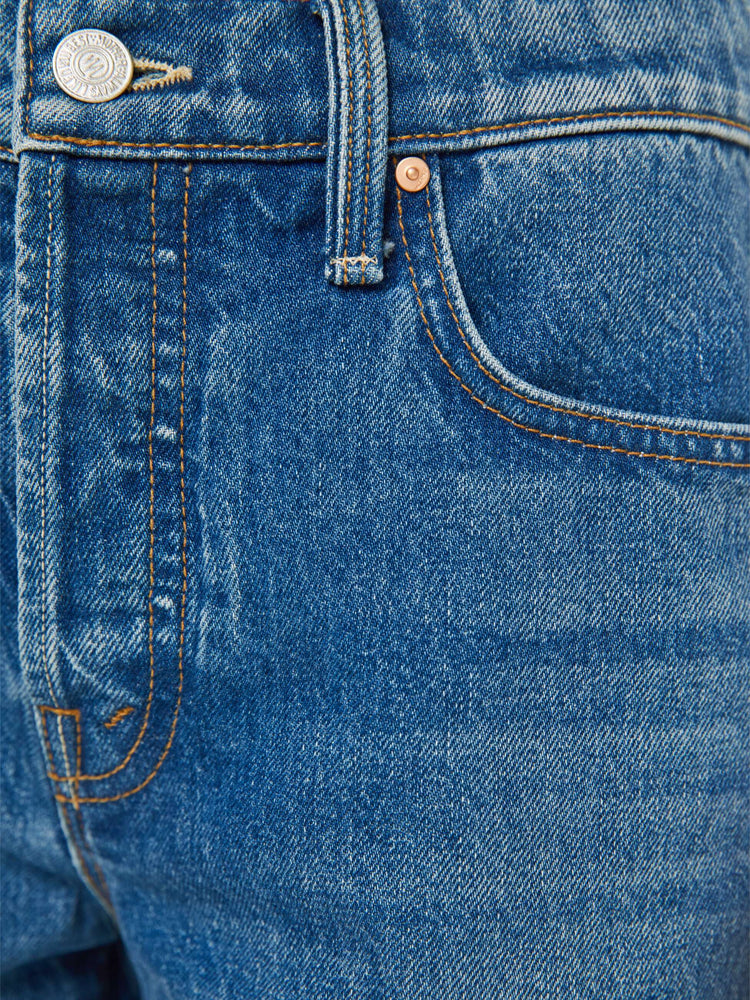 Swatch view of a woman in a classic blue high-rise straight leg denim capri with a zip fly, 16-inch inseam and a frayed hem.