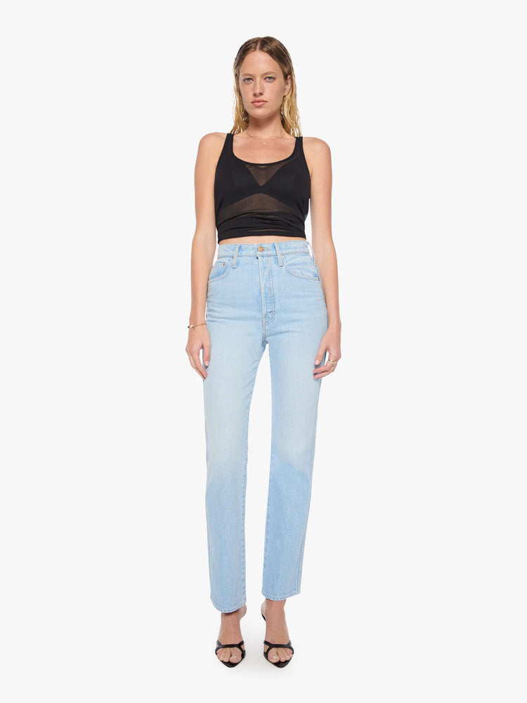 Front view of a woman in a light blue  super high-waisted pants have a button fly, slightly tapered straight leg, a long 32-inch inseam and a clean hem. 