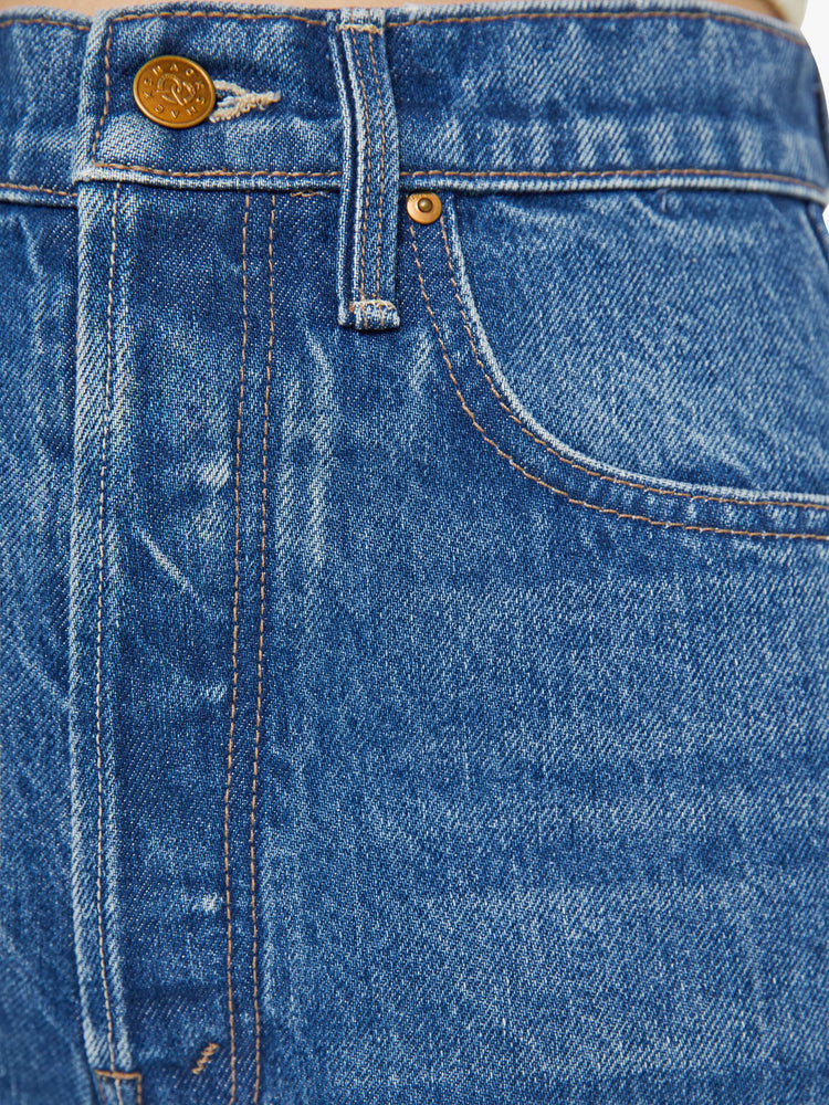 Swatch view of a woman in a mid blue super high-waisted pants have a button fly, slightly tapered straight leg, a long 32-inch inseam and a clean hem.