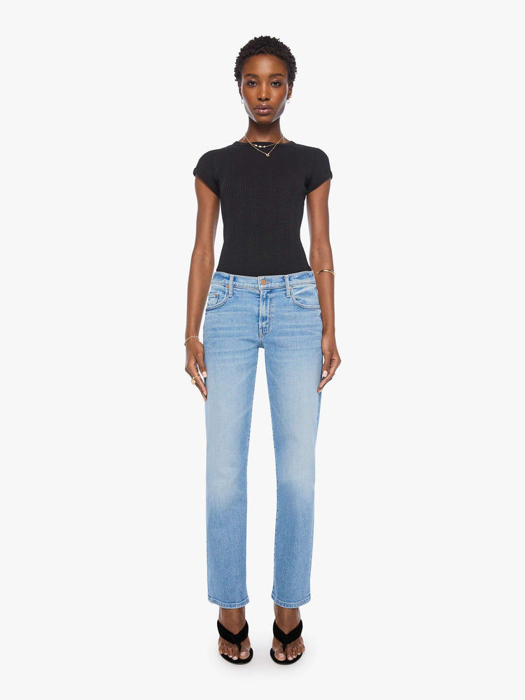 Front view of a woman in light blue  lower-rise bootcut with a zip fly, 31-inch inseam and a clean hem. 