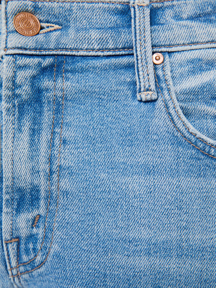 Swatch view of a woman in light blue  lower-rise bootcut with a zip fly, 31-inch inseam and a clean hem. 