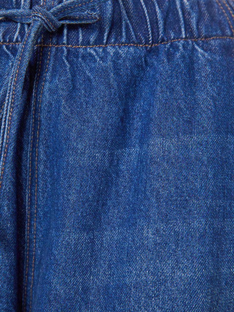 Swatch view of a woman in a super high-waisted jeans have a loose straight leg, elastic drawstring waistband, zip fly and a 30-inch inseam with a clean hem.