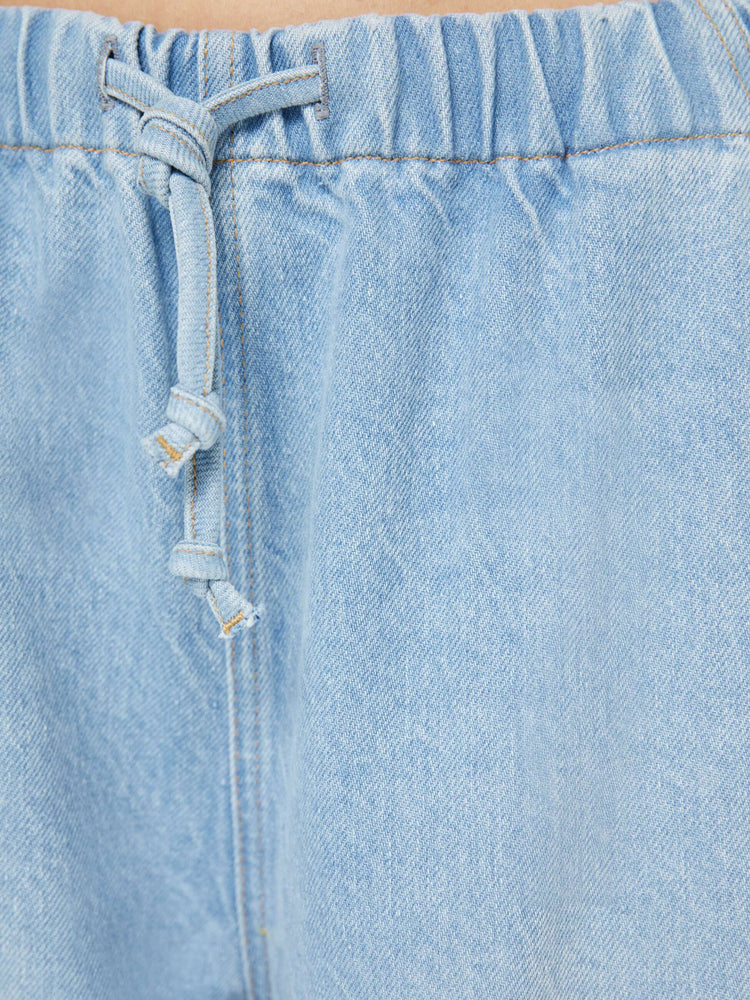 Swatch view of a woman in a super high-waisted jeans have a loose straight leg, elastic drawstring waistband and a 30-inch inseam with a clean hem. 