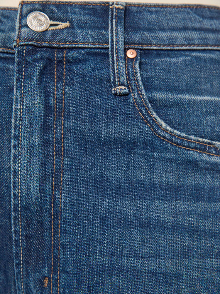 Swatch view of a woman in a mid blue super high-waisted barrel-leg jeans with a relaxed fit, zip fly, inset panels on the outer seams, long 31-inch inseam and a clean hem. 
