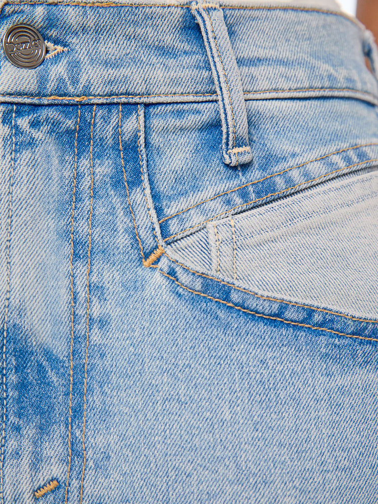Swatch view of a woman in a light blue high-rise jean has a straight leg, zip fly, angled contrast cut-outs at the hips, a 29-inch inseam and a clean hem.