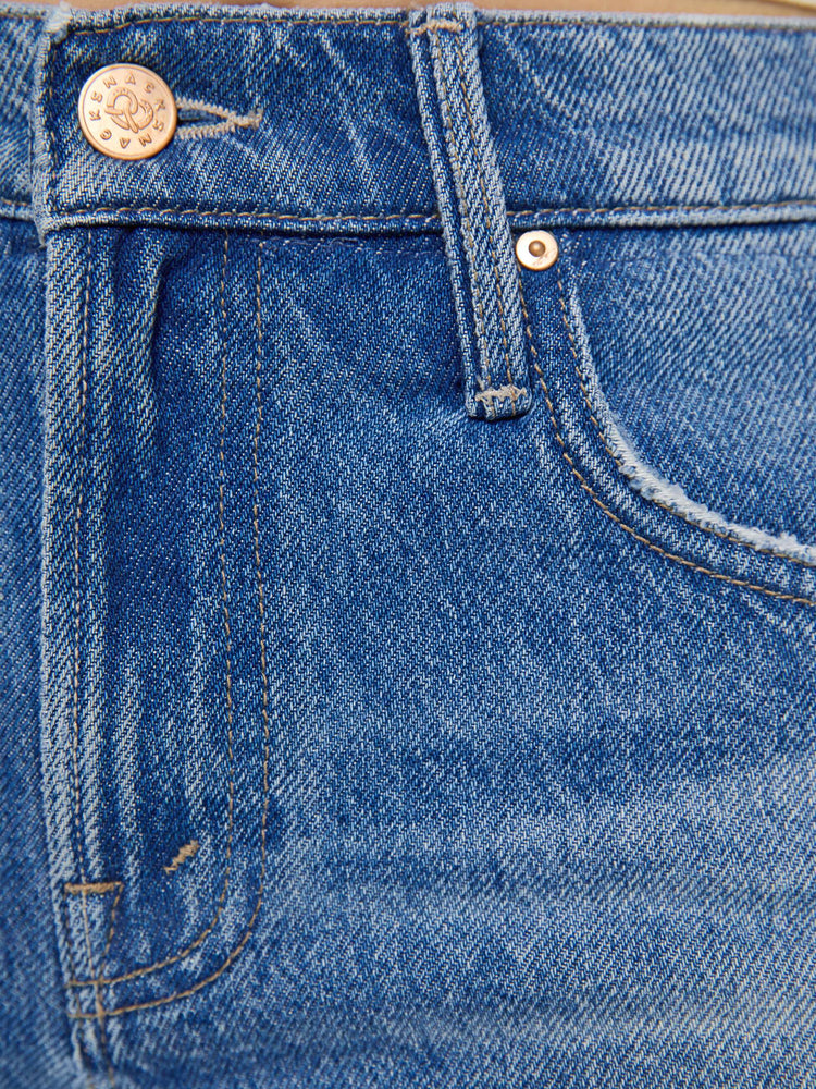 Swatch view of a woman in a lower-rise jeans are designed to look like a pair of frayed shorts is layered on top, and are designed with a zip fly, narrow straight-leg, long 34-inch inseam and a clean hem.