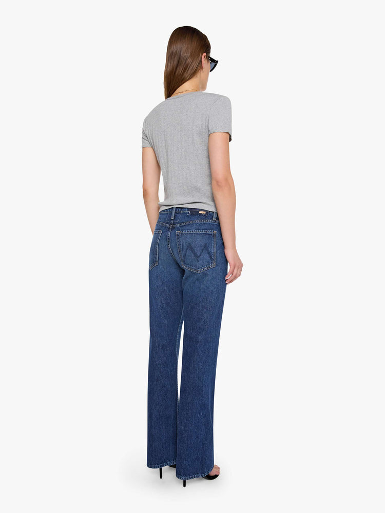 Back view of woman in a mid-rise bootcut with a zip fly, looser leg, twisted outer seam and a long 32-inch inseam with a clean hem.