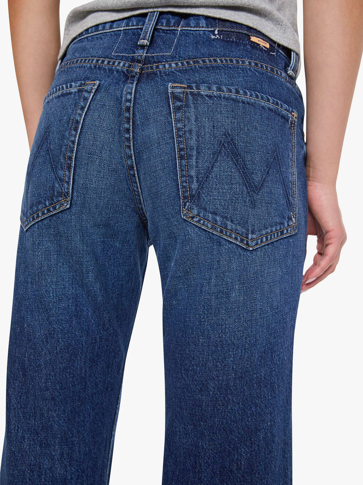 Close up butt view of woman in a mid-rise bootcut with a zip fly, looser leg, twisted outer seam and a long 32-inch inseam with a clean hem.