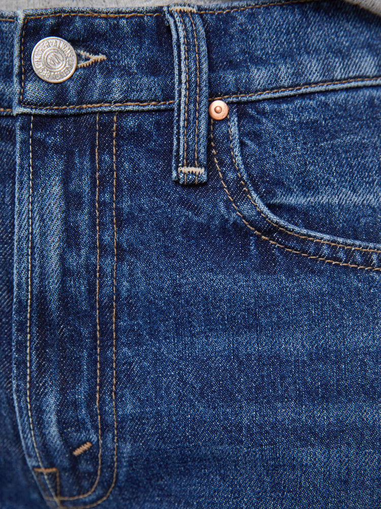 Swatch view of woman in a mid-rise bootcut with a zip fly, looser leg, twisted outer seam and a long 32-inch inseam with a clean hem.