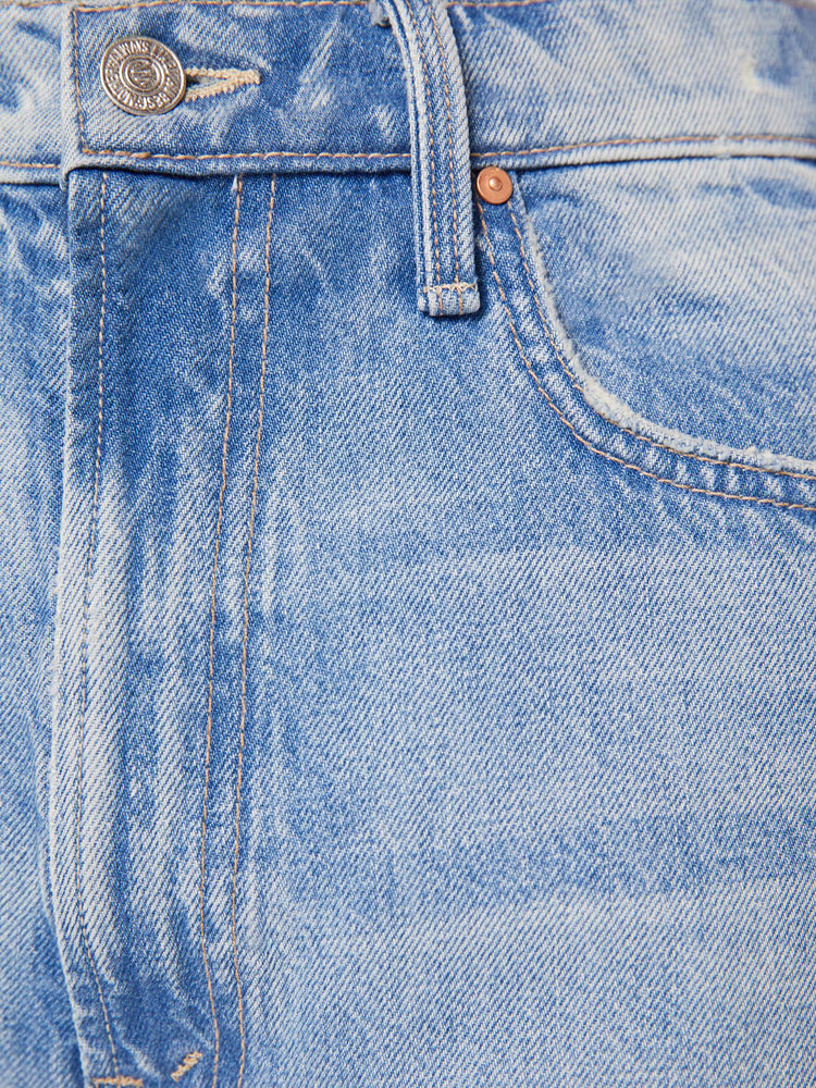 Swatch view of a woman in a light blue high-waisted jeans with a wide barrel leg, zip fly and a 29-inch inseam with a frayed hem.