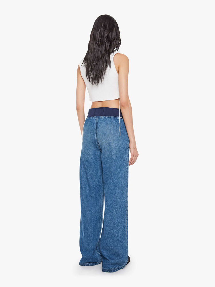 Back  view of a woman in a high-waisted wide-leg jeans are designed with a drawstring elastic waistband, slit pockets and a 32-inch inseam with a clean hem.