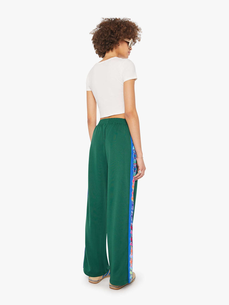 Back view of a woman in a green vintage color pant with an elastic waistband and a loose straight-leg.