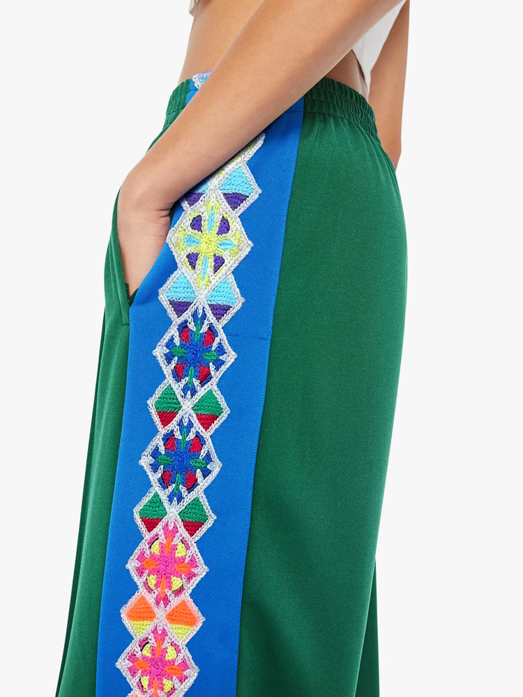 Close up view of a woman in a green vintage color pant with an elastic waistband and a loose straight-leg.