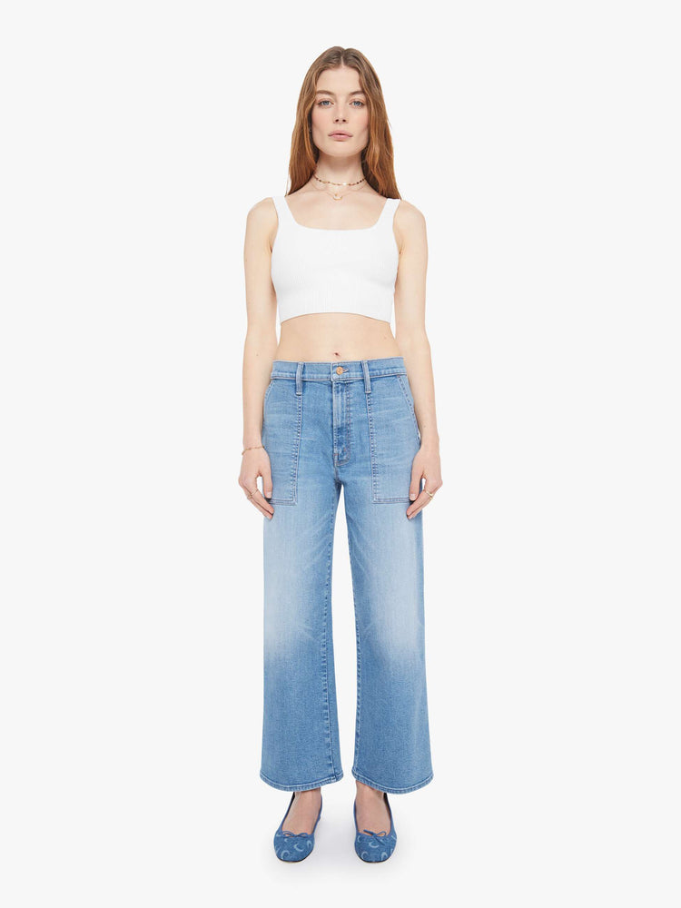 Front view of a woman in a light blue super high-waisted jeans with a loose fit, wide leg, zip fly, patch pockets and a 28.25-inch inseam with a clean hem.