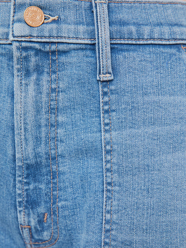 Swatch view of a woman in a light blue super high-waisted jeans with a loose fit, wide leg, zip fly, patch pockets and a 28.25-inch inseam with a clean hem.