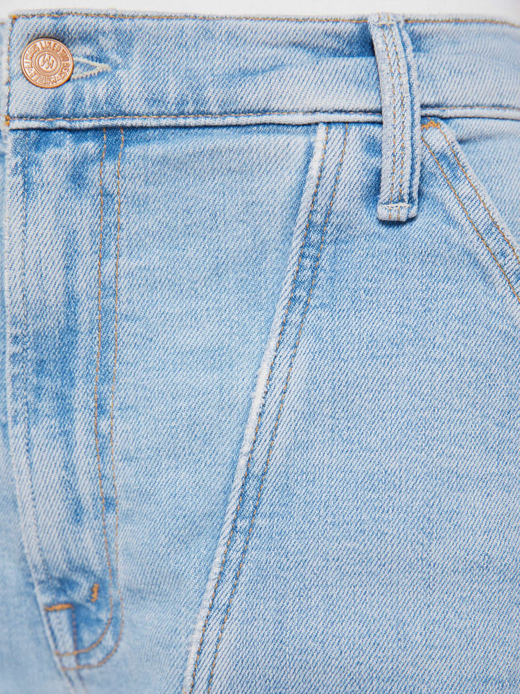 Swatch view of a woman in a light blue wide-leg jeans with a super high rise, zip fly, utility-inspired patch pockets, hammer loop, angled seamed details across the front and a long 32-inch inseam with a clean hem.