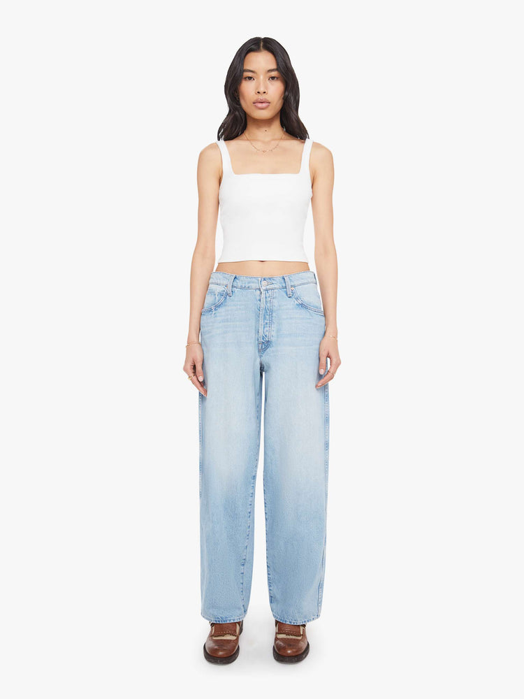 Front view of a woman in jeans designed to sit lower on the hips with a button fly, a 30-inch inseam, clean hem and slightly tapered leg.