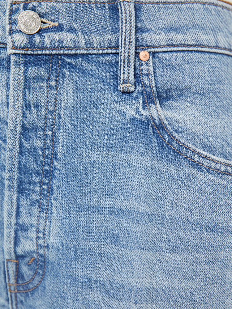 Swatch view of a woman in a light blue jeans designed to sit lower on the hips with a button fly, a 30-inch inseam, clean hem and slightly tapered leg.