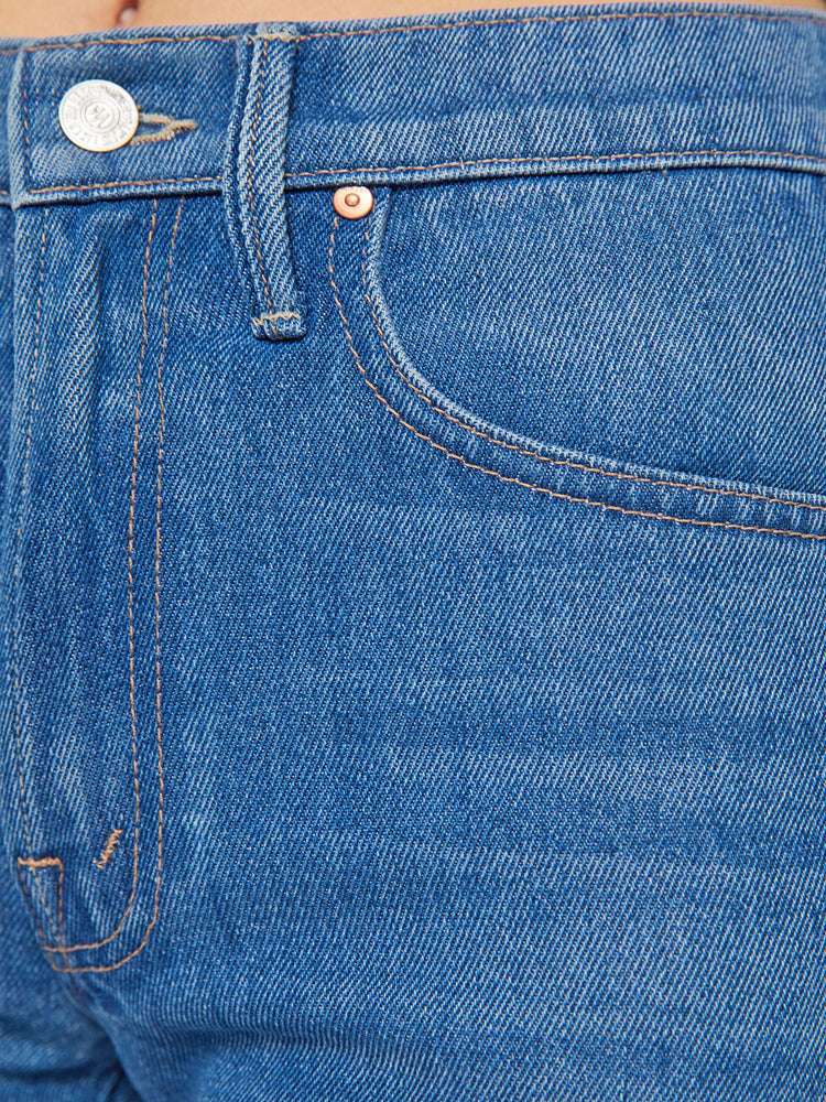 Swatch view of a woman in a mid blue wide-leg pants with a zip fly, mid rise and 33-inch inseam with a clean hem. 