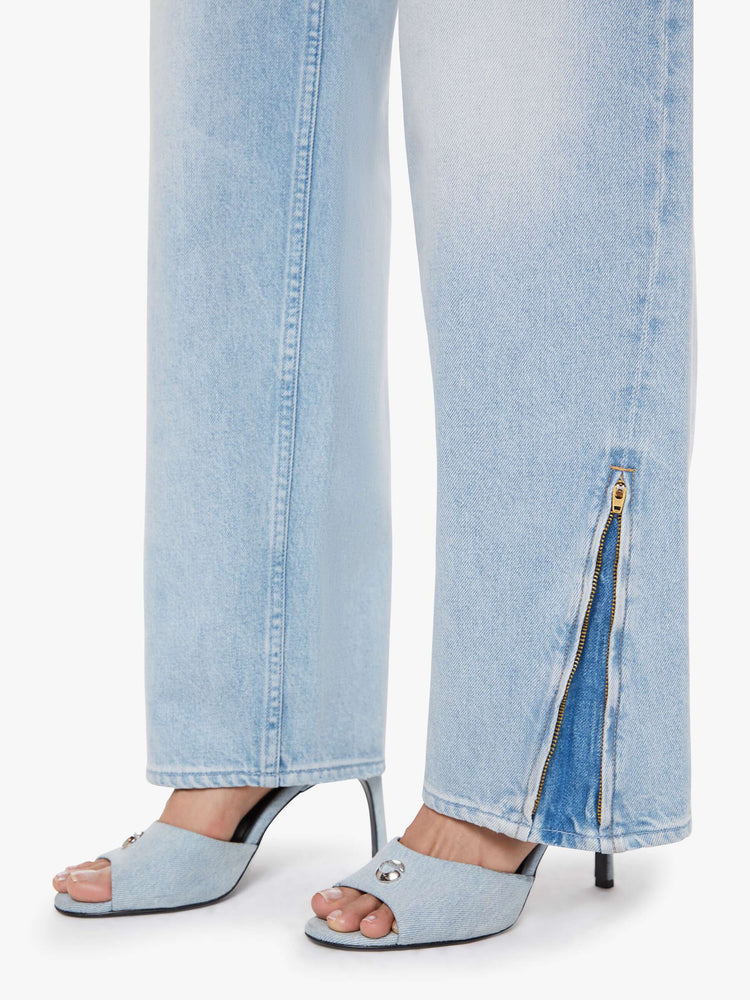 Hem view of a woman in a light blue high-waisted jeans with a loose wide leg, zip fly and a long 34-inch inseam with a clean hem that can be zipped for a more tapered fit.