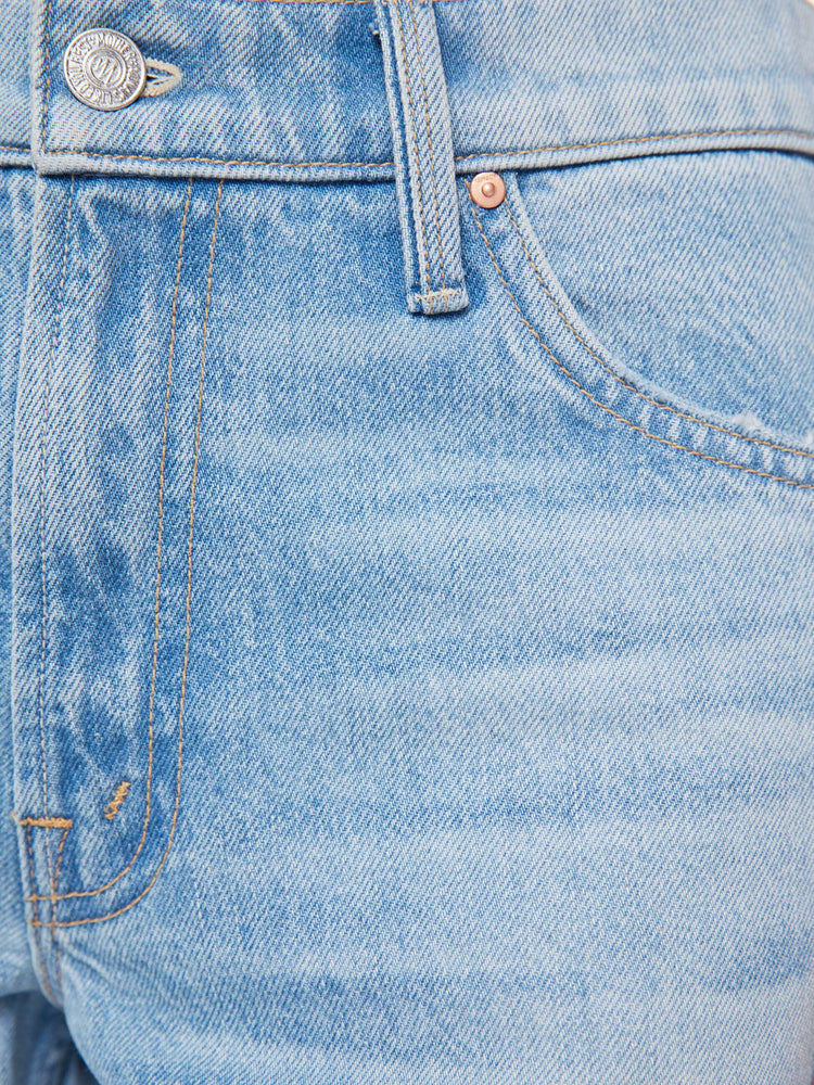 Swatch view of a woman in a light blue high-waisted jeans with a loose wide leg, zip fly and a long 34-inch inseam with a clean hem that can be zipped for a more tapered fit.
