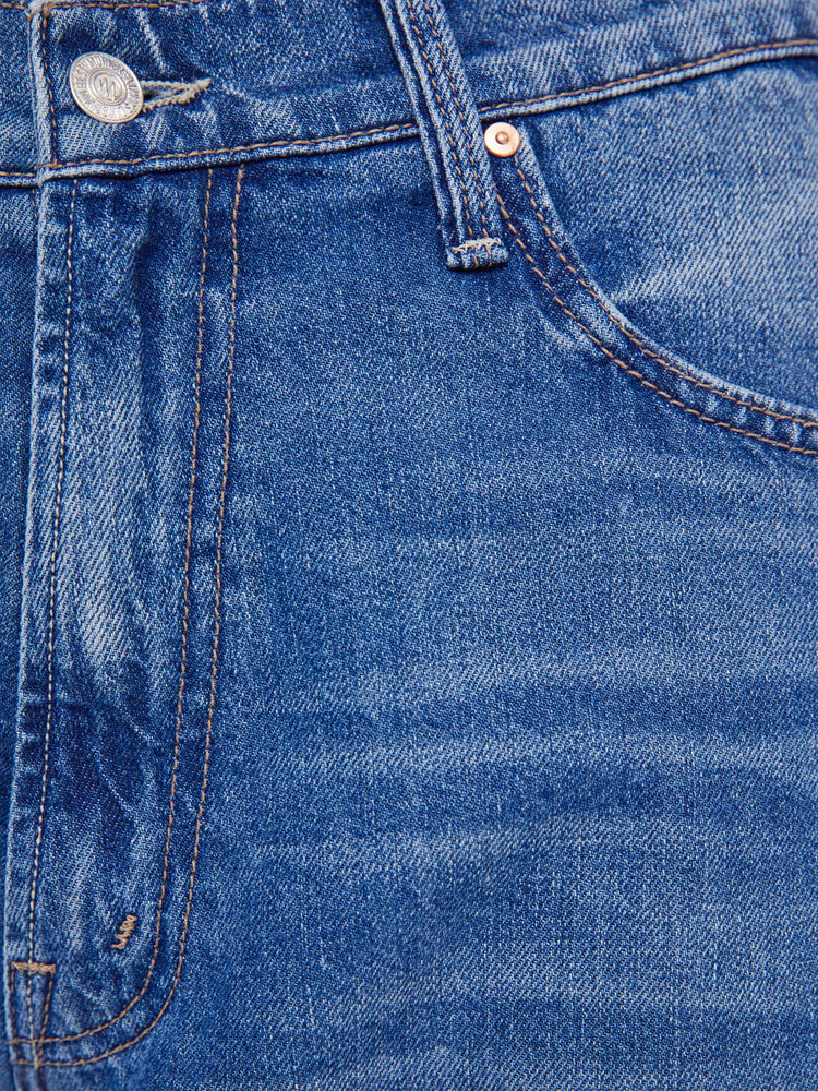Swatch view of a woman in a mid blue   jeans designed to sit lower on the hips with a 28-inch inseam, zip fly, clean hem and slightly tapered leg. 