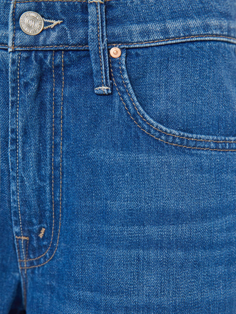 Swatch view of a woman in med blue mid-rise jeans with a loose fit, wide leg, zip fly and a 31-inch inseam with a clean hem.