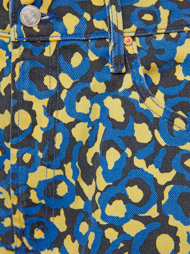 Swatch view of a woman in lower on the hips  jean with an ankle-length inseam, zip fly, clean hem and slightly tapered leg in a a blue, yellow and black leopard print.