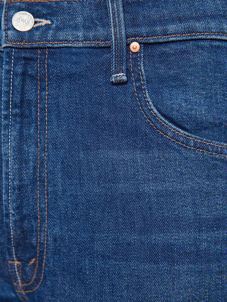 Swatch view of a woman in a dark blue jeans designed to sit lower on the hips with an ankle-length inseam, zip fly, clean hem and slightly tapered leg.