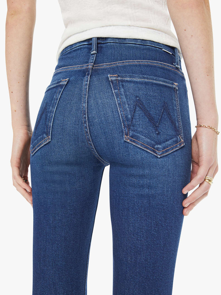 Close up view of a woman in a skinny high rise jean with a zip fly, 29-inch inseam and a clean hem.
