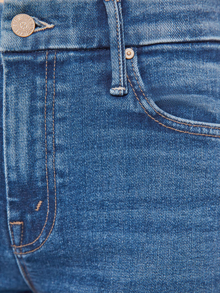 Swatch view of a woman in a med blue skinny with a high rise with a zip fly, 29-inch inseam and a clean hem. 