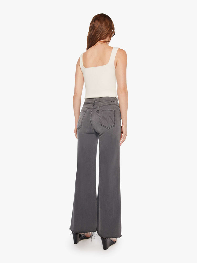 Back view of women's grey high waisted wide leg jean with a frayed hem.