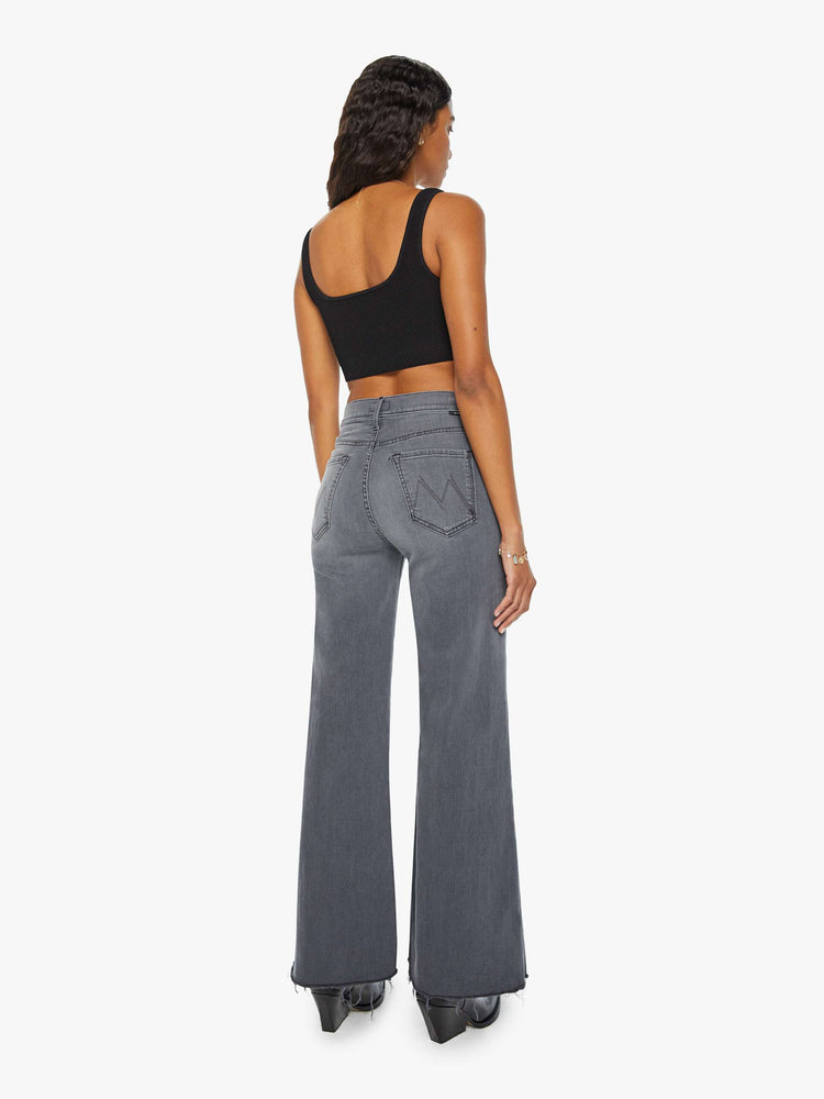 Back view of women's grey high waisted wide leg jean with a frayed hem